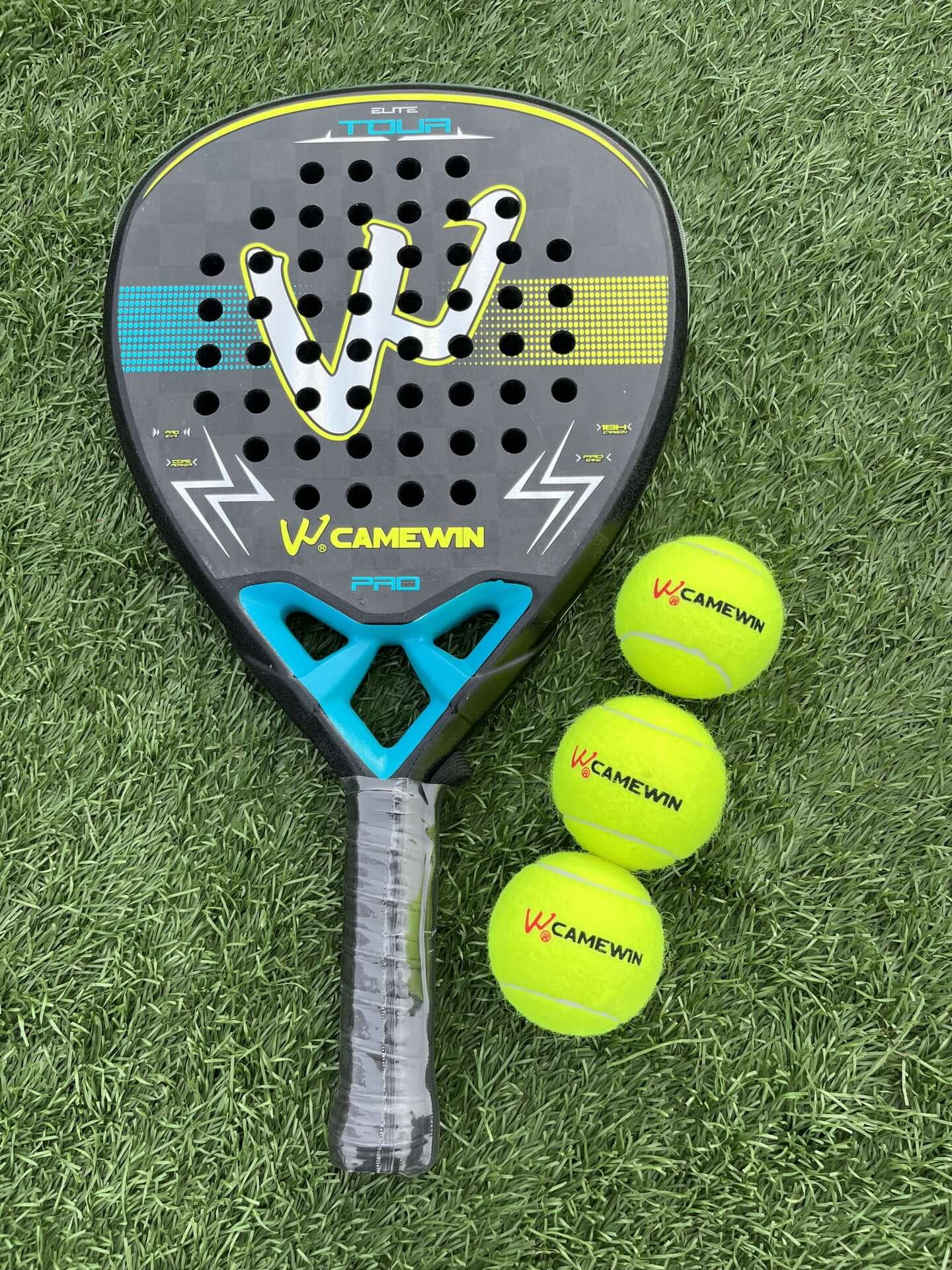 18K Transparent Carbon Tennis Rackets displayed with tennis balls on a green grass background.