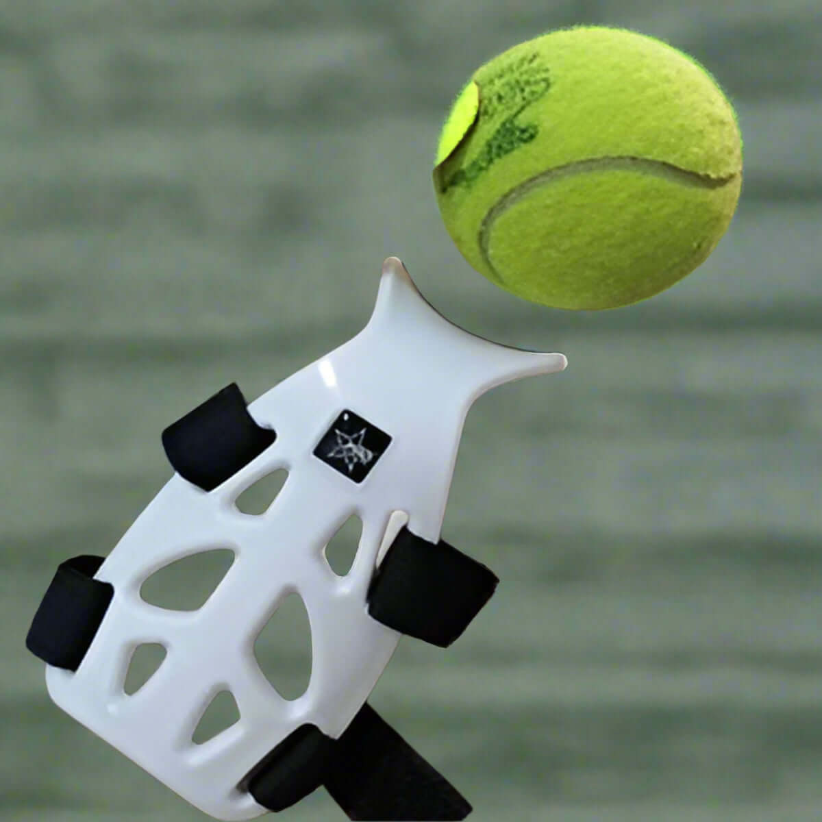 Wrist guard support for tennis, lightweight design, protecting wrist during play with tennis ball in motion.