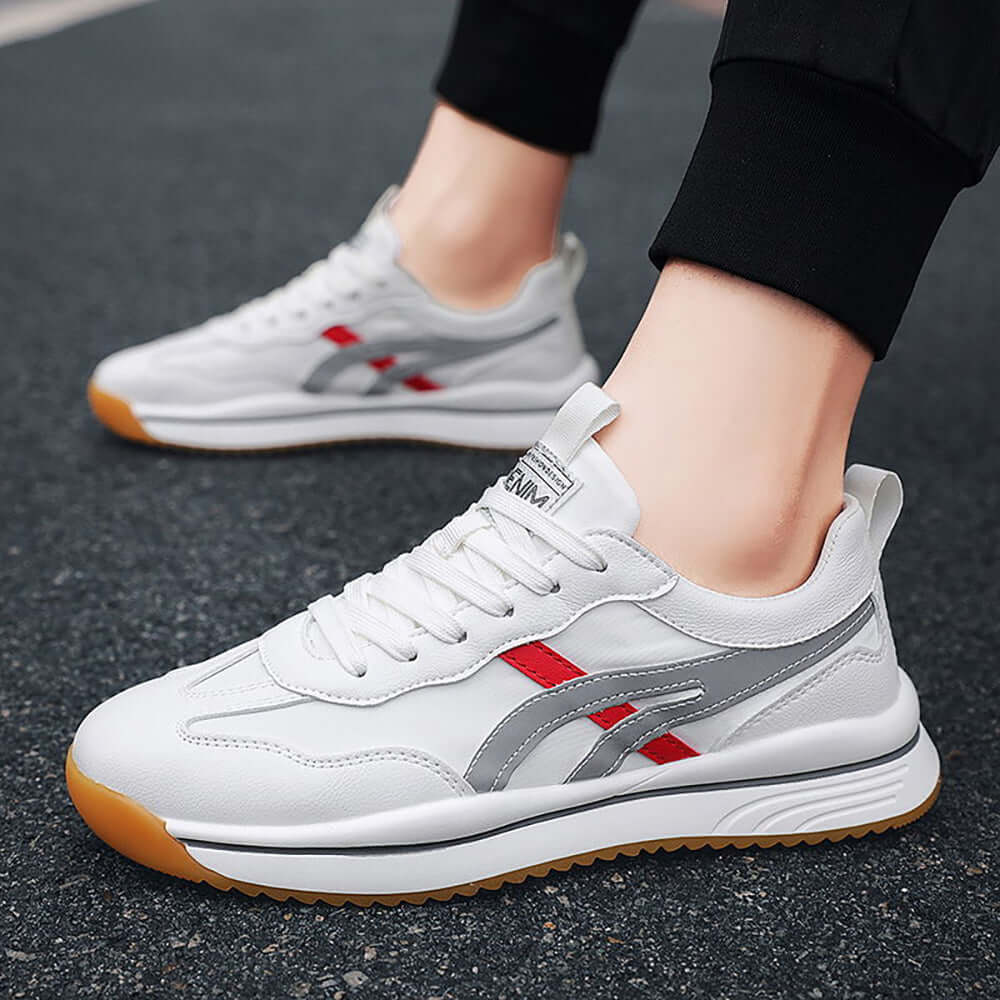 Tennis sneakers for men in white with red and gray accents, perfect for on-court performance and casual wear.