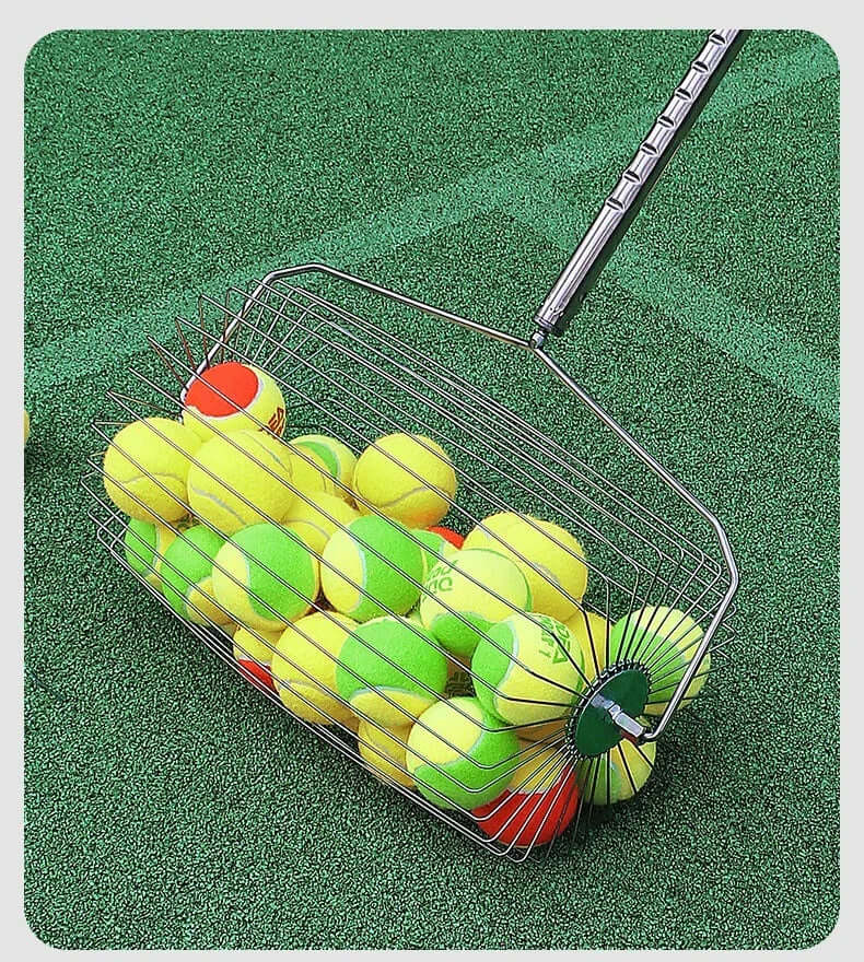Adjustable tennis ball picker with tennis balls on a green court surface.