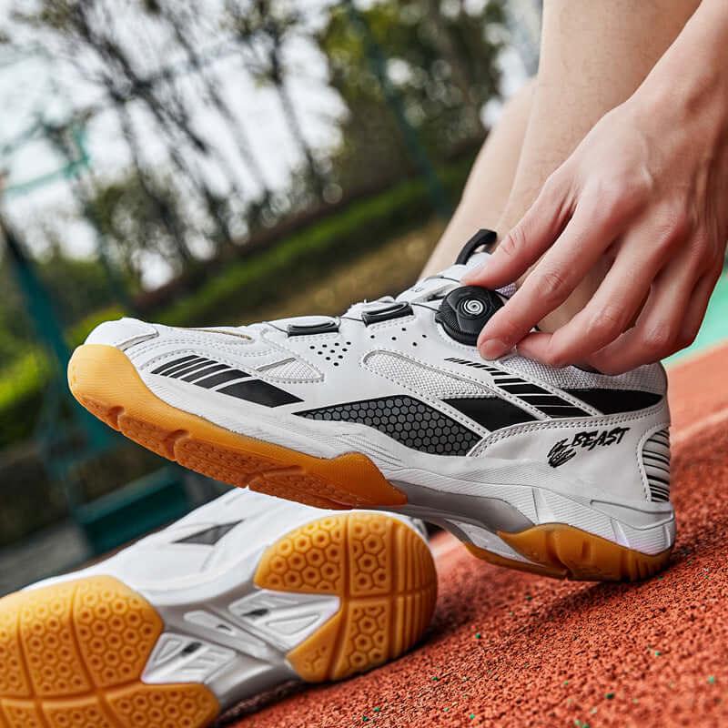 Person adjusting breathable tennis shoes on a court showing lightweight comfort and style.