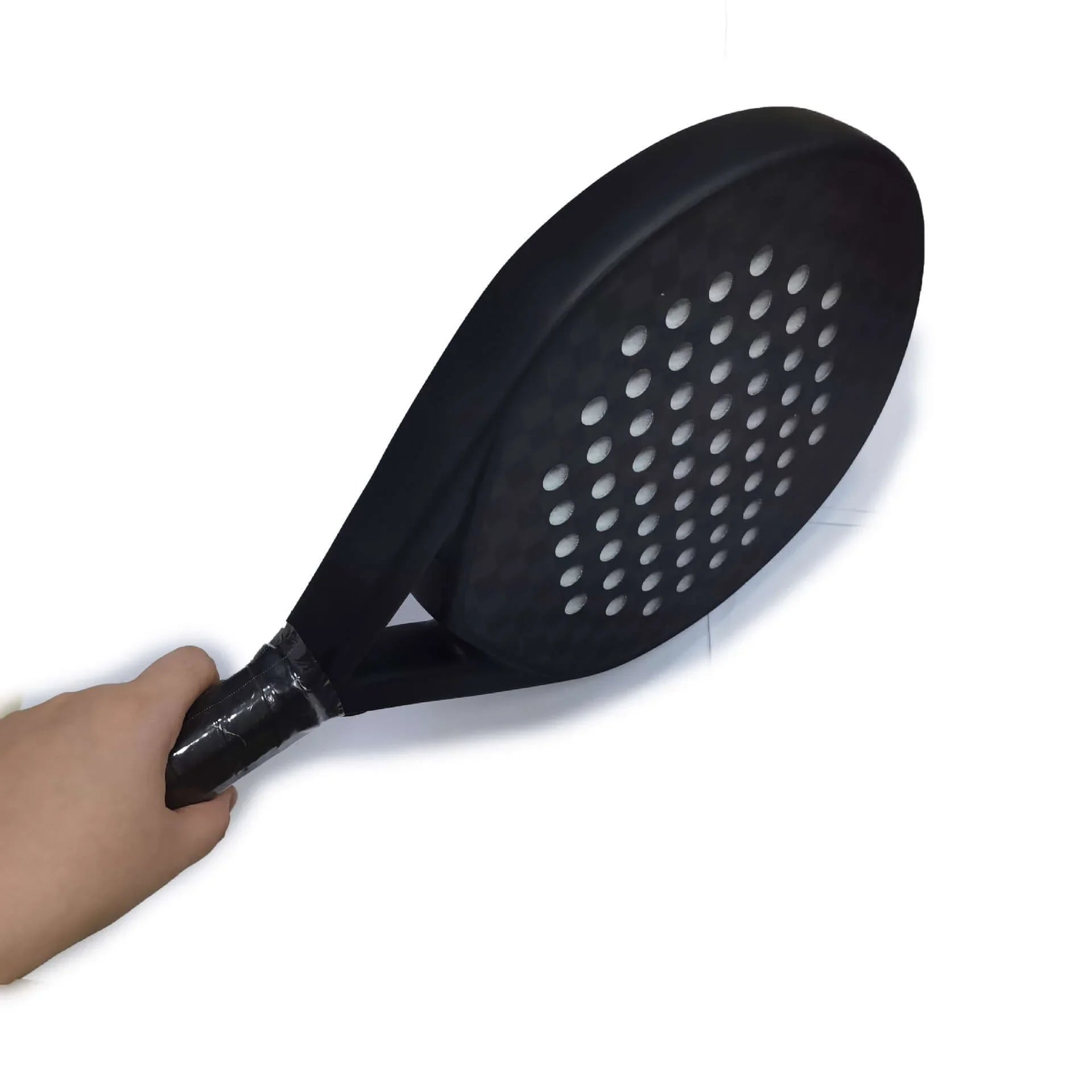 Carbon Fibber Padel Racket held in hand, showcasing its lightweight design and perforated surface for improved performance.