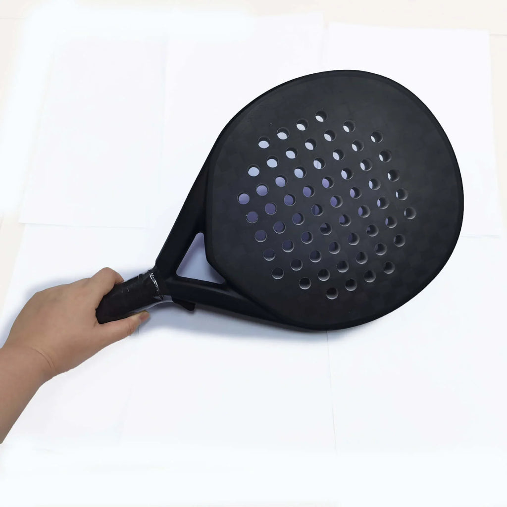 Carbon Fibber Padel Racket, lightweight racket for power and control, held in hand on white background.