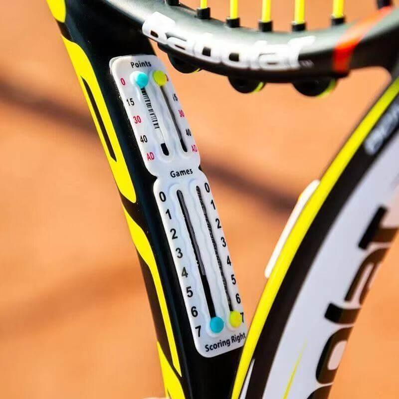 Tennis racket accessories scorer for tracking points and games during practice sessions.