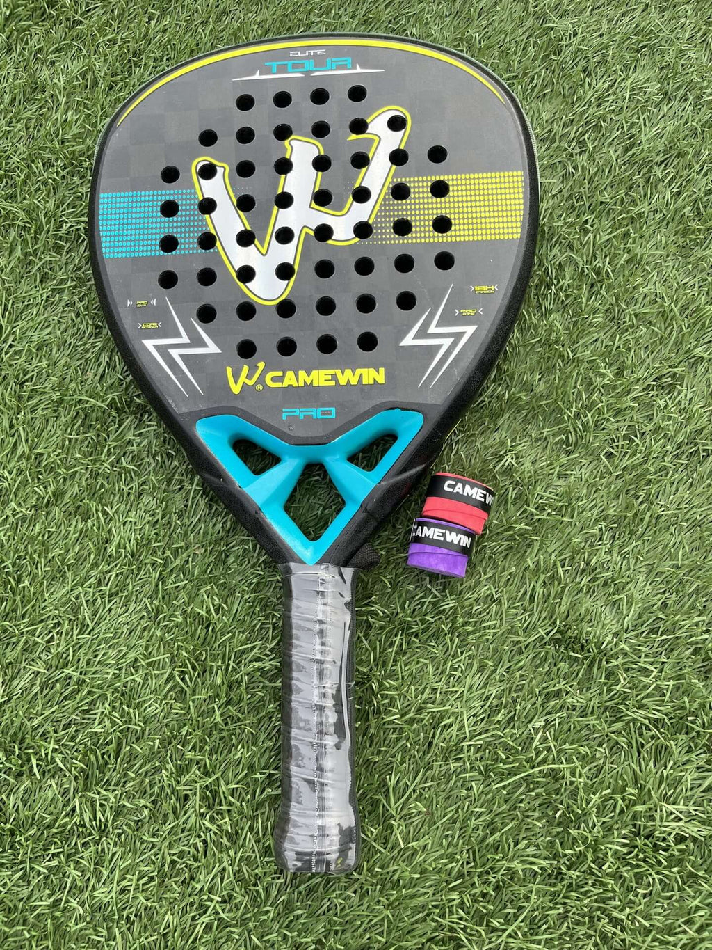 18K Transparent Carbon Tennis Rackets on green turf, showcasing bold design and responsive grip.