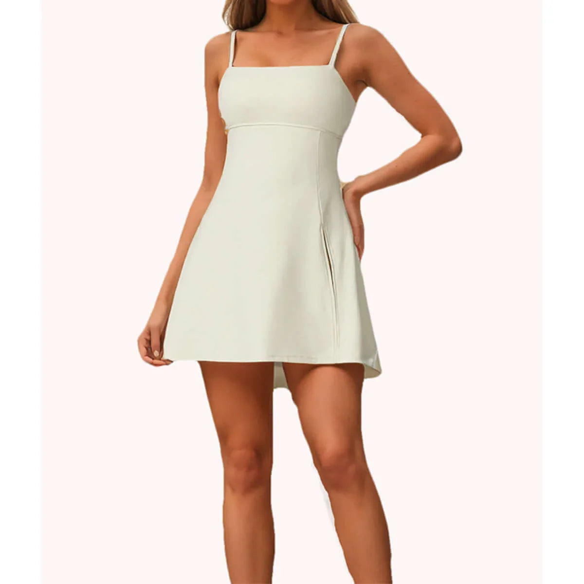 Women's tennis dress with shorts in light color, designed for sporty elegance and mobility on the court.