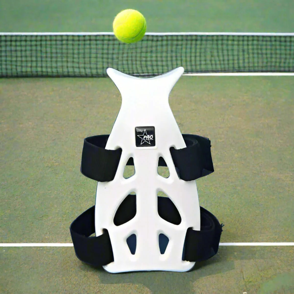 Wrist guard support for tennis on a court with a tennis ball overhead, showcasing its lightweight design.