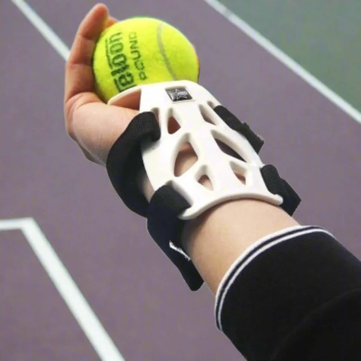 Wrist guard support for tennis on a player's wrist holding a tennis ball, showcasing lightweight and dual-hand design.